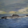 В море.